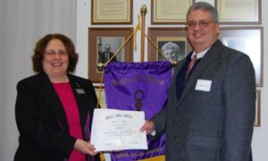 Dr. Ferran receives his honorary membership from Dr. Curtis.